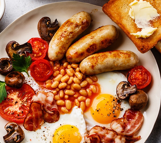Example of serving breakfast: boiled sausages with eggs and beans, photo by Gourmet Food Store